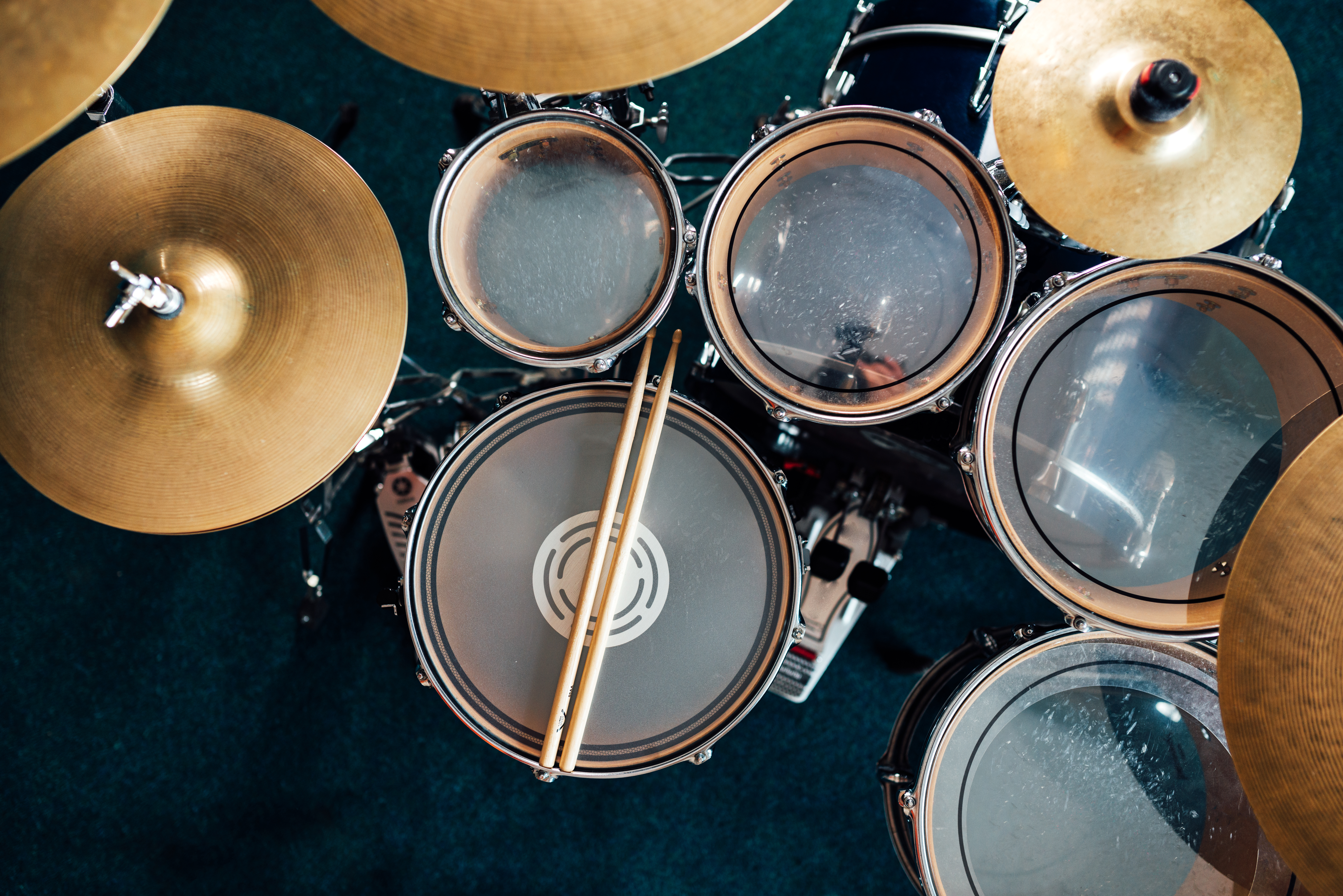 top-view-complete-drumset-drumsticks-lie-on-a-dru-2021-09-24-04-28-28-utc
